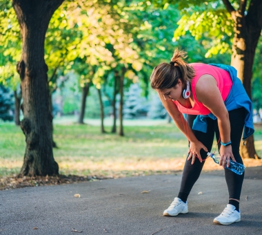 woman exhausted after running in a public park